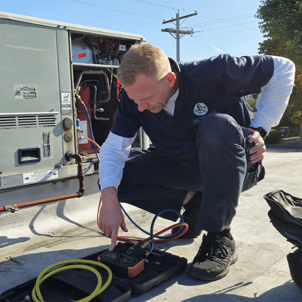 Mr. Fridge commercial technician repairing a cooling unit on a commercial building.