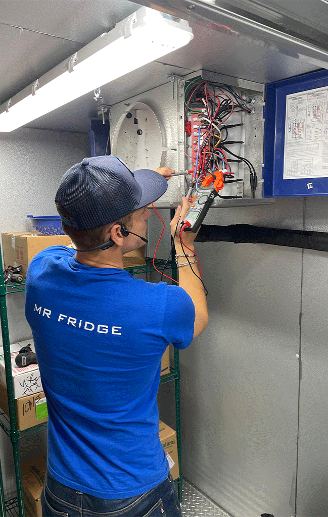 a commercial fridge service technical from a company called Mr. Fridge is performing repair on commercial fridge in the greater seattle area.