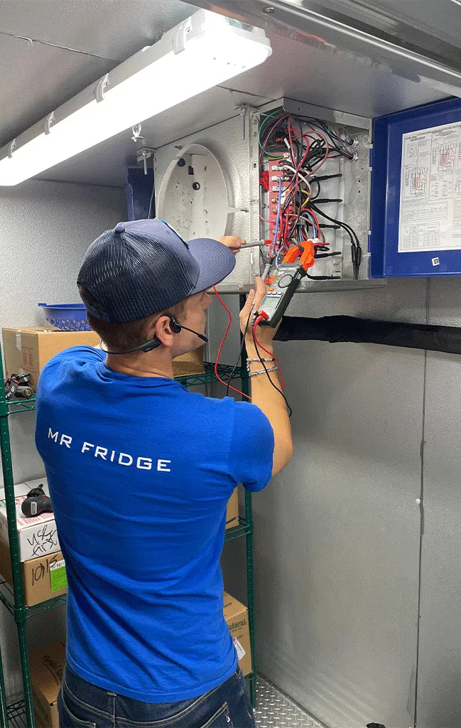a commercial fridge service technical from a company called Mr. Fridge is performing repair on commercial fridge in the greater seattle area.