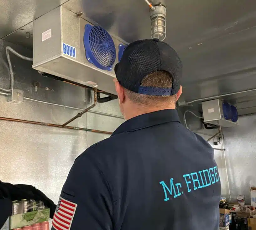 Mr. Fridge Walk-In Cooler Repair Service - Seattle WA Mr. Fridge technician inspecting a walk-in cooler refrigeration unit during a commercial repair in Seattle, WA.