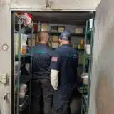 two mr.fridge technicians repairing
