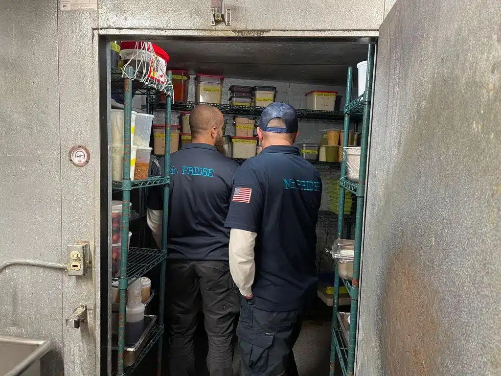 two mr.fridge technicians repairing